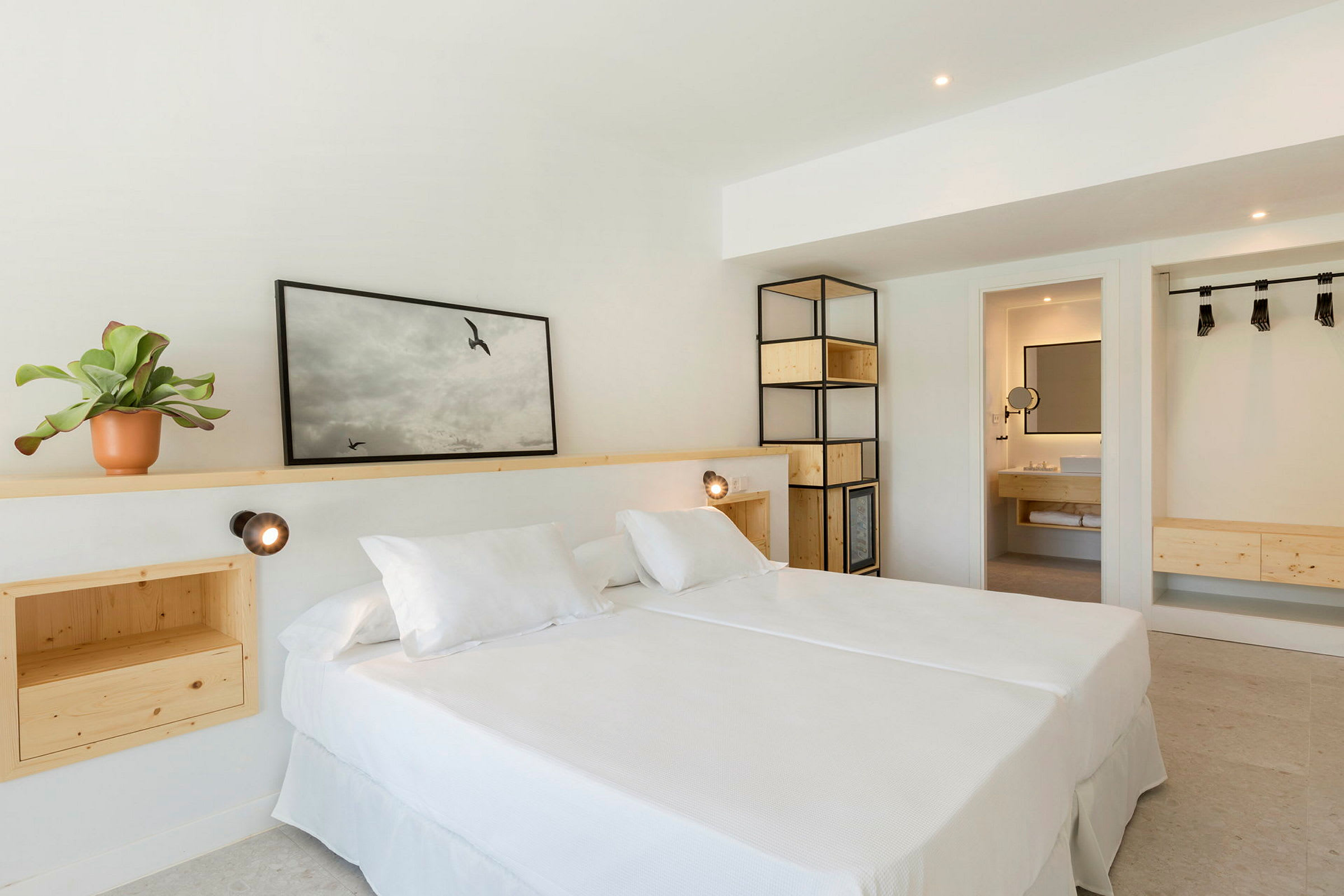Ett ljust hotellrum med en dubbelsäng och inredning av trä. (AI-genererad text)
