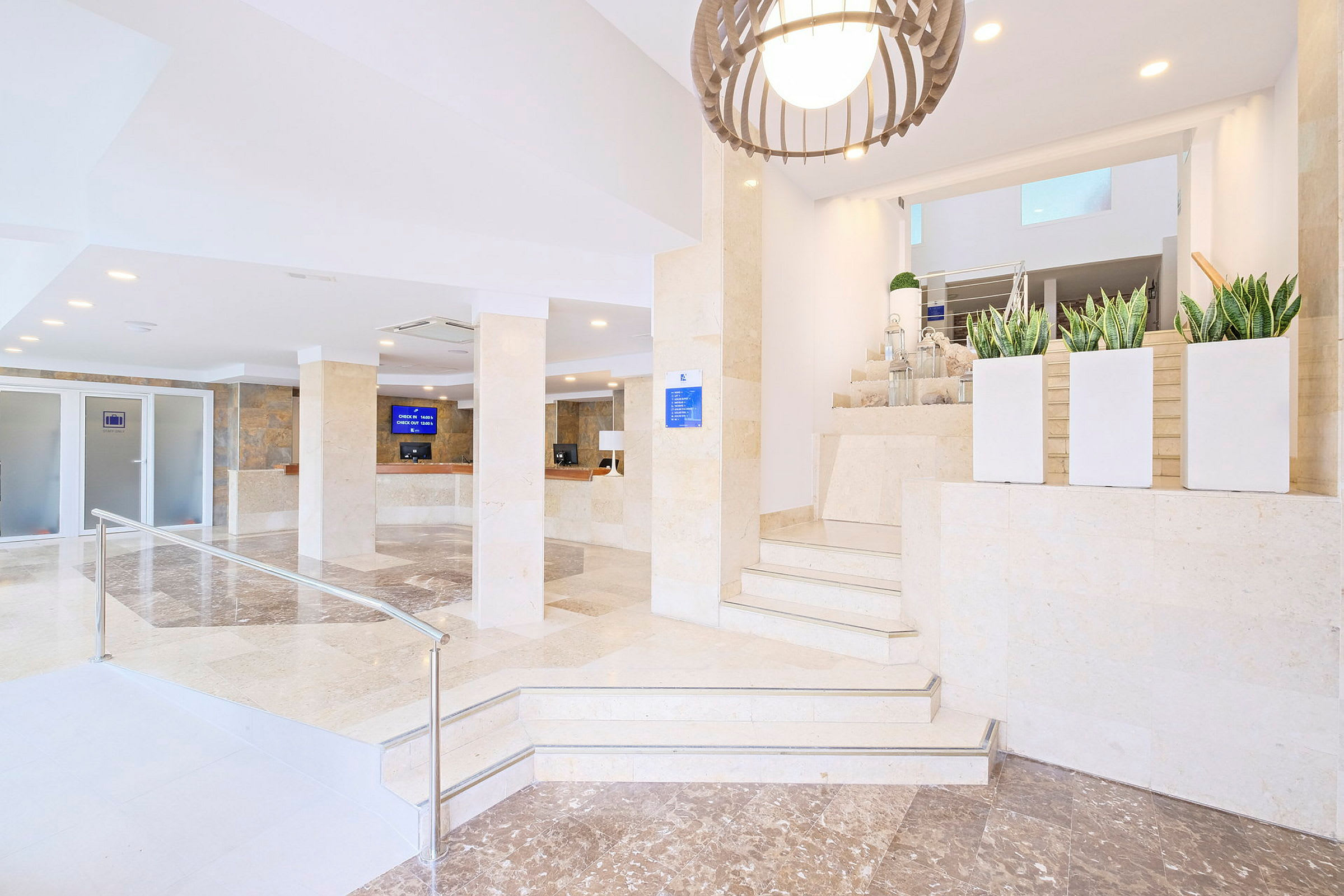 En hotellreception med marmorgolv, disk, och dekorativa växter samt en belysning hängande från taket. (AI-genererad text)