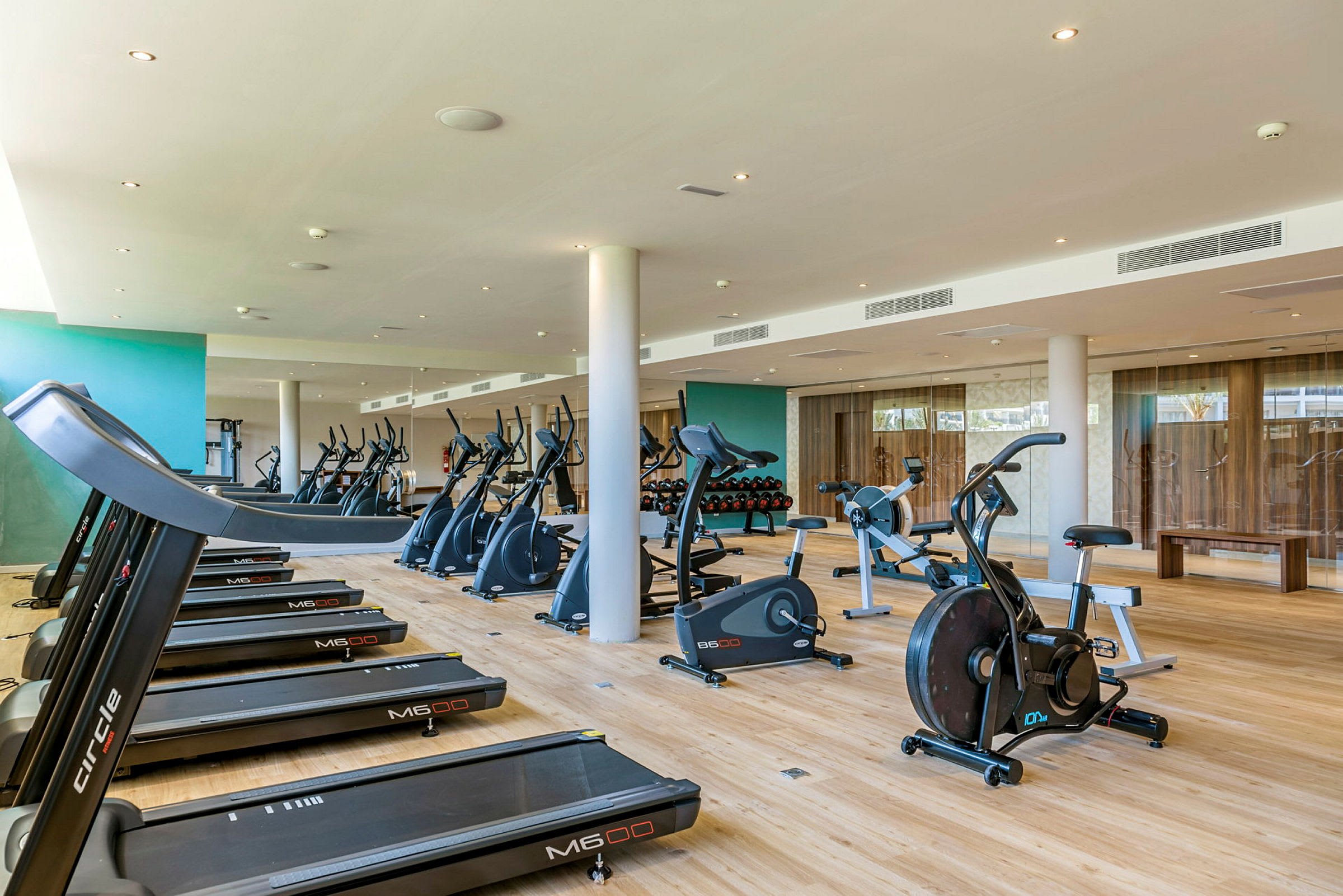 Ett gym med träningsmaskiner inklusive löpband och motionscyklar. (AI-genererad text)