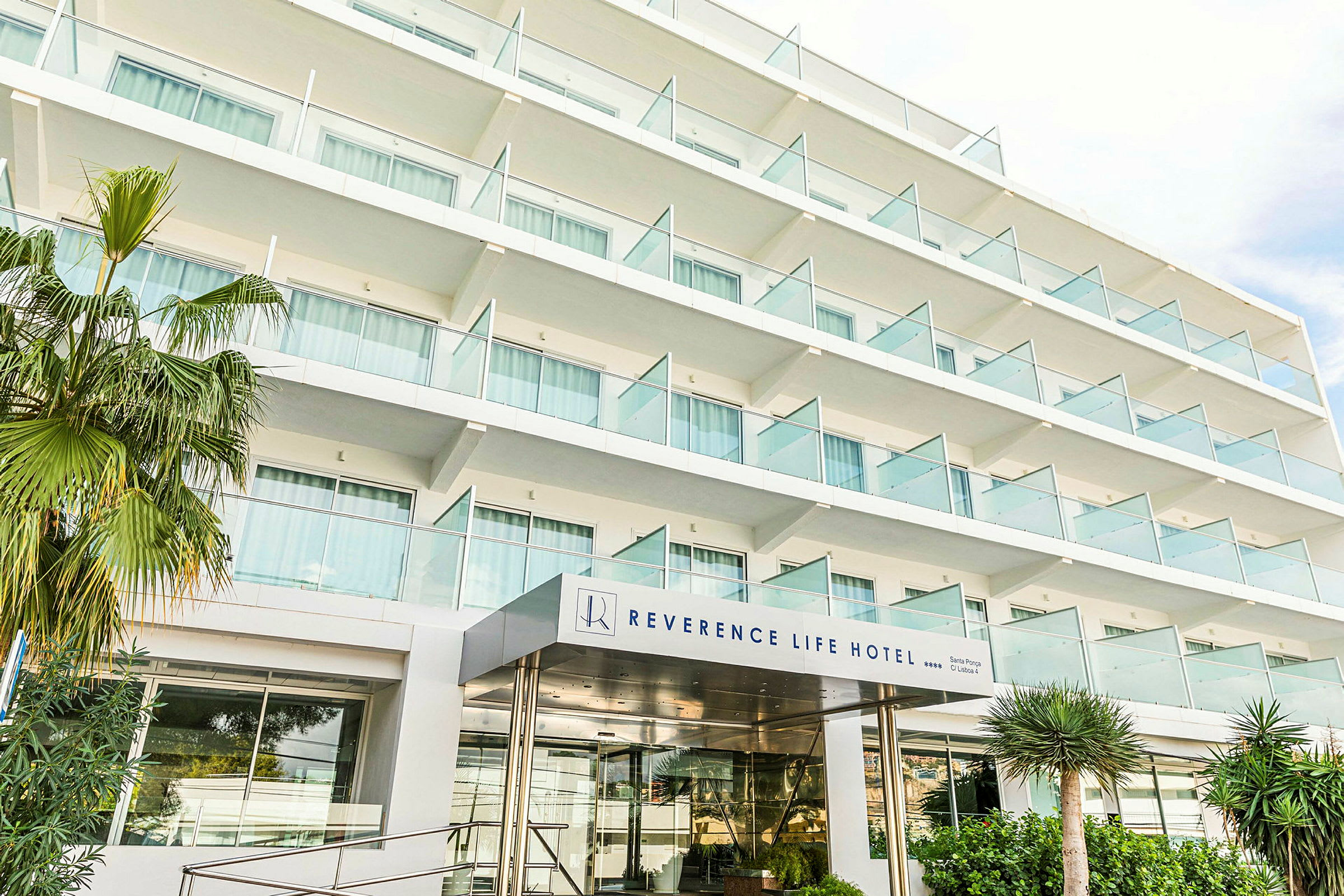 Byggnaden visar ett hotellkomplex med flera våningsplan och glasbalkonger. (AI-genererad text)