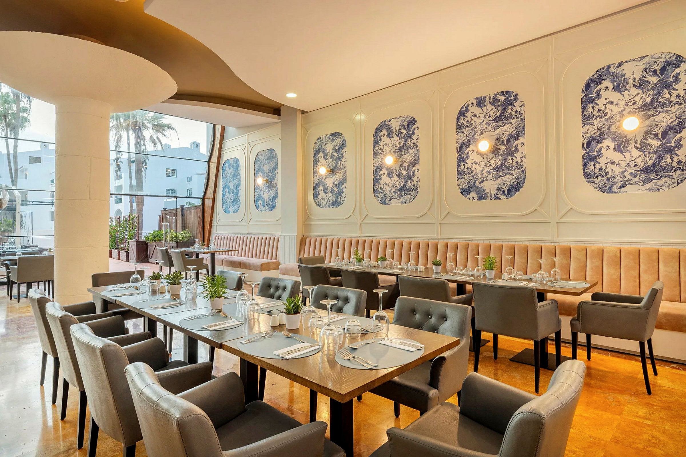 Interiör av en restaurang med eleganta bord och stolar, och blå dekorationer på väggen. (AI-genererad text)