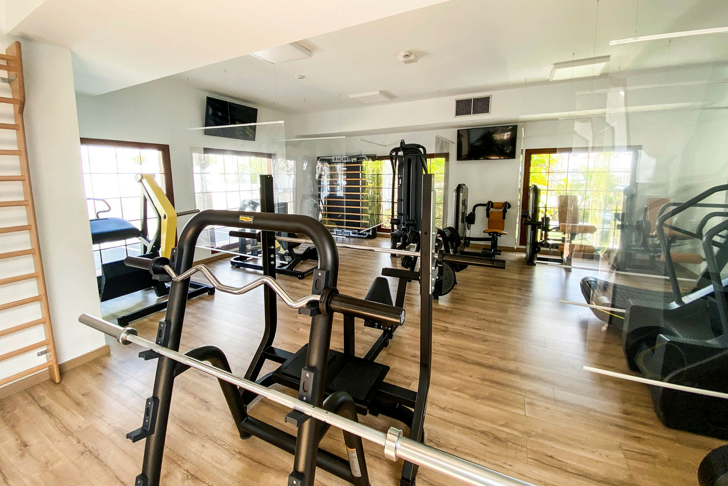 Bild av ett gym med träningsmaskiner och redskap. (AI-genererad text)