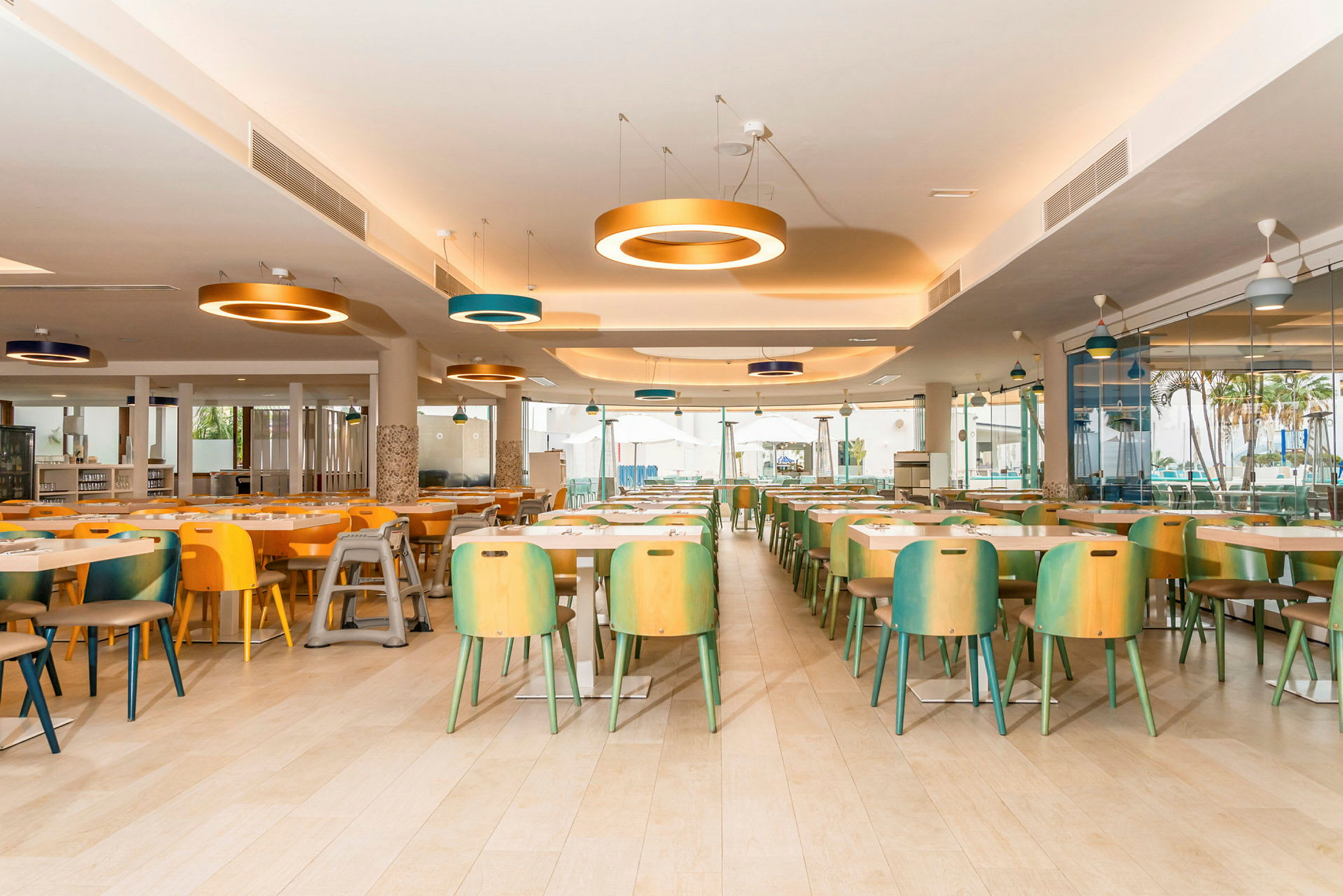 Restaurang med flera färgglada stolar och bord, modern belysning. (AI-genererad text)