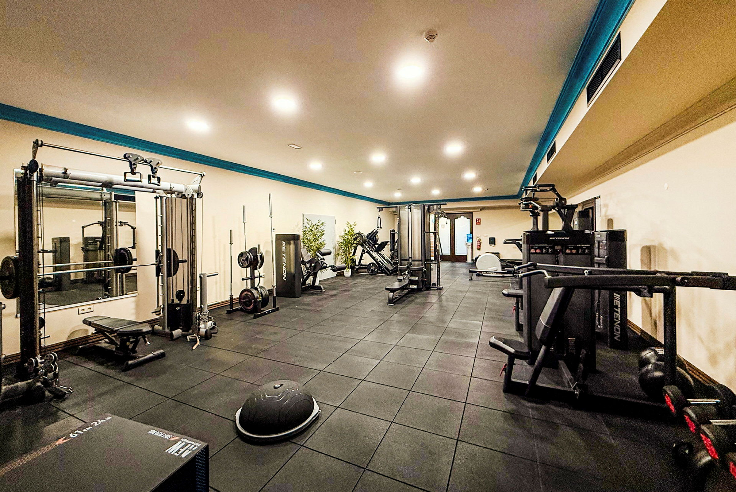 Gym med träningsutrustning och belysning. (AI-genererad text)