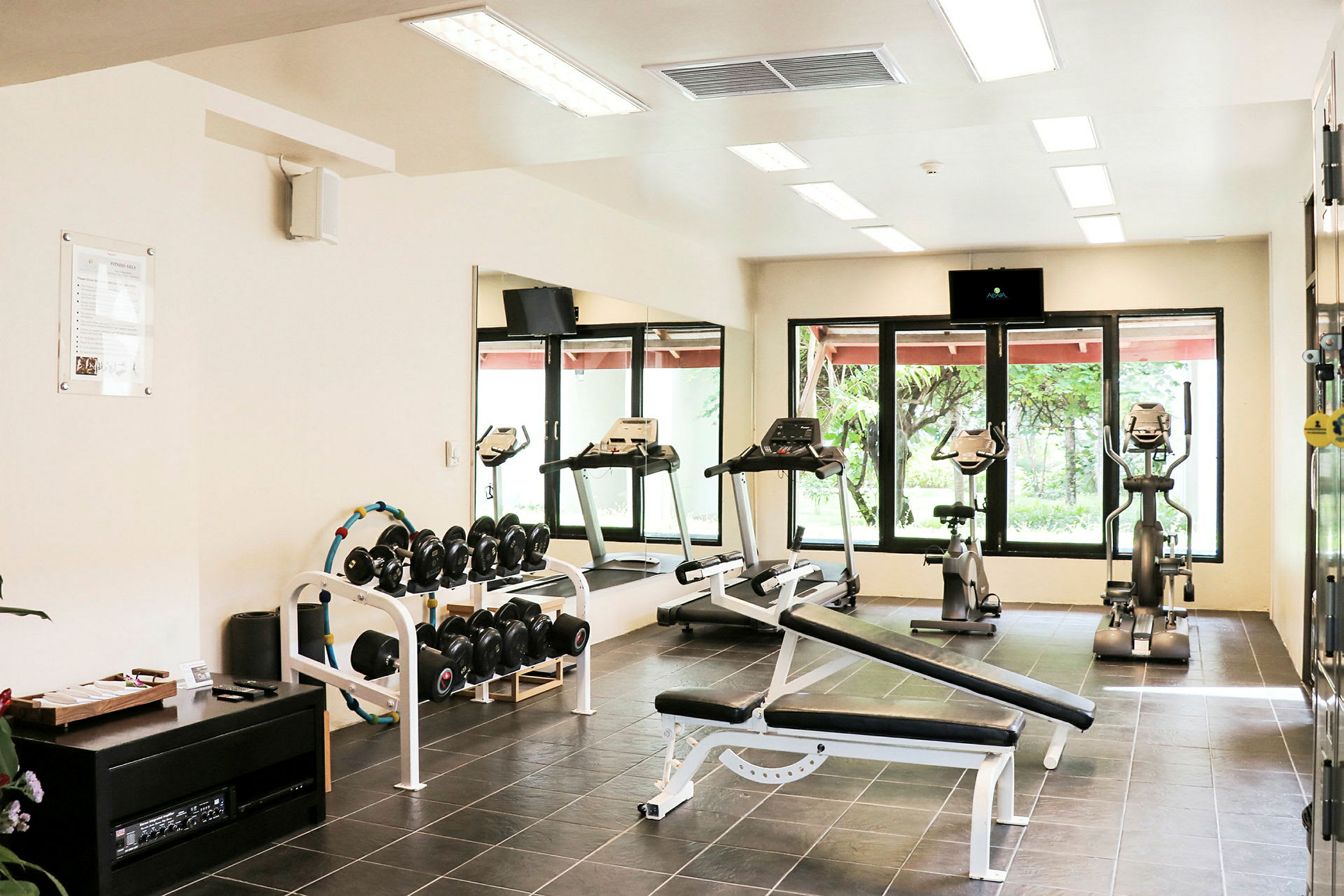 Bild av ett gym med träningsutrustning som löpband och hantlar. (AI-genererad text)