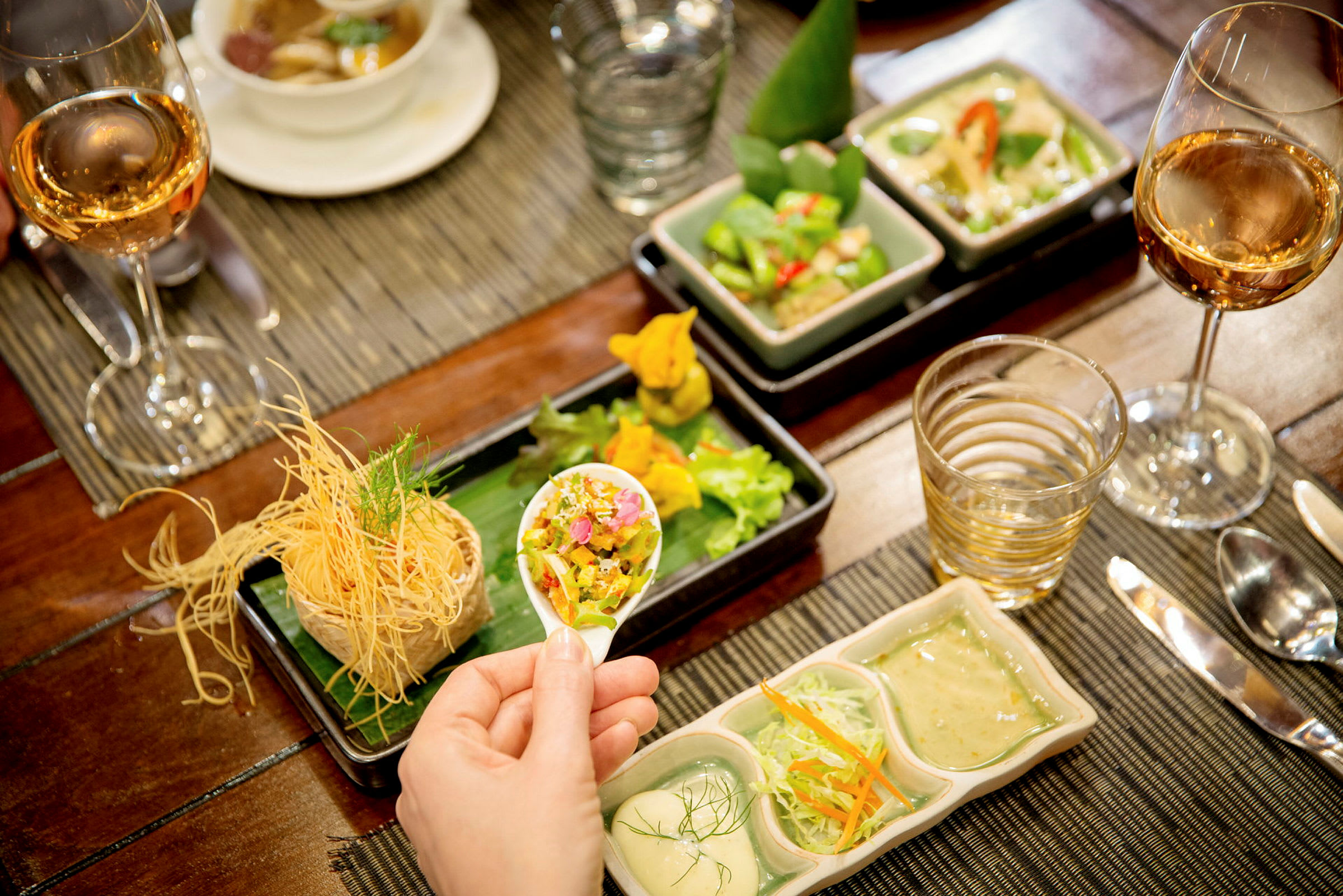 En borddukning med olika asiatiska rätter och vin serverat. (AI-genererad text)