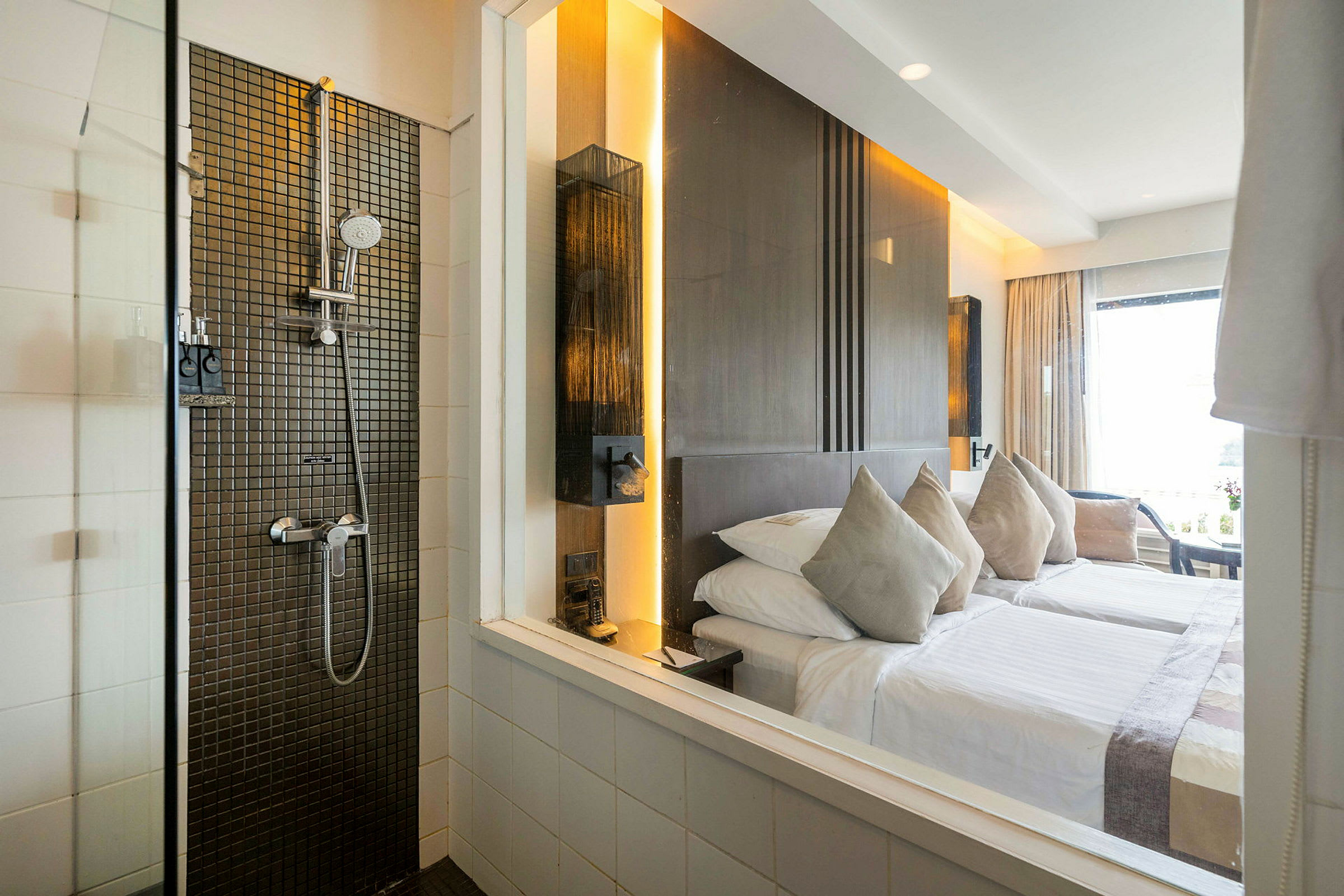 Hotellrum med en säng och en duschdel med modern design. (AI-genererad text)