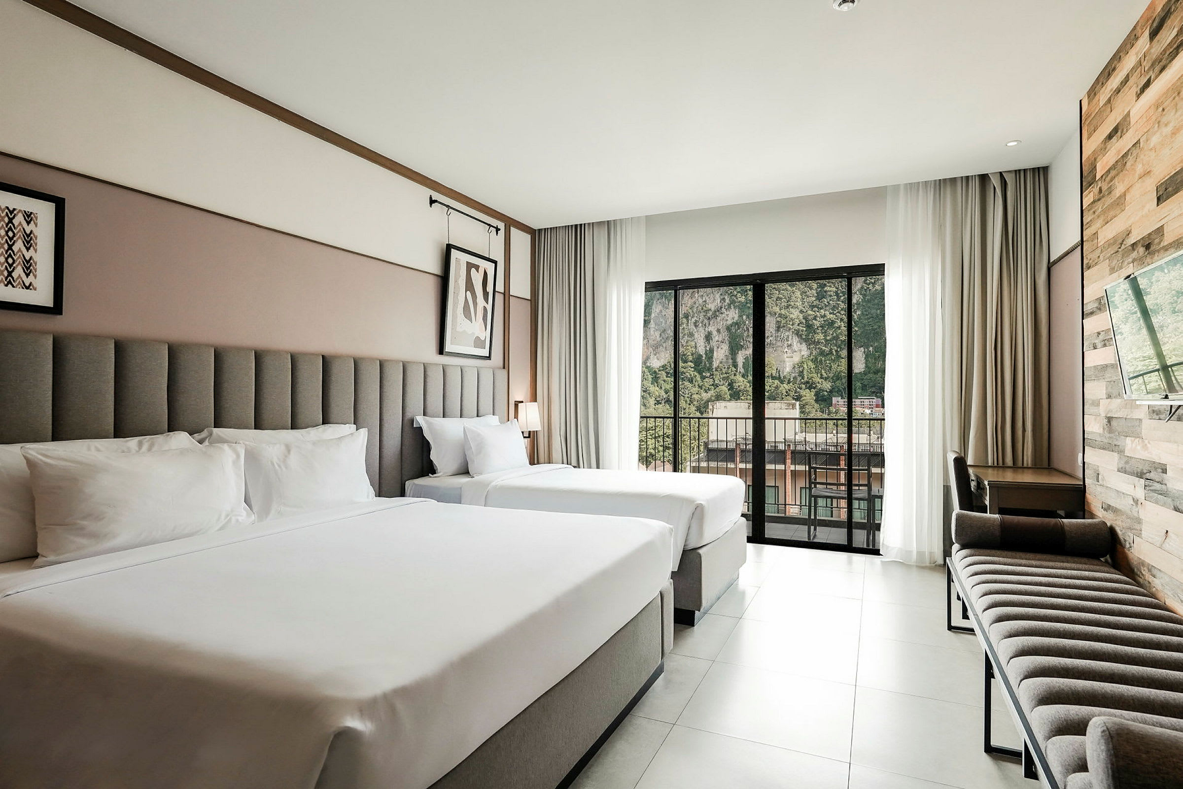 Ett hotellrum med två sängar och en balkong som vetter mot utsidan. (AI-genererad text)