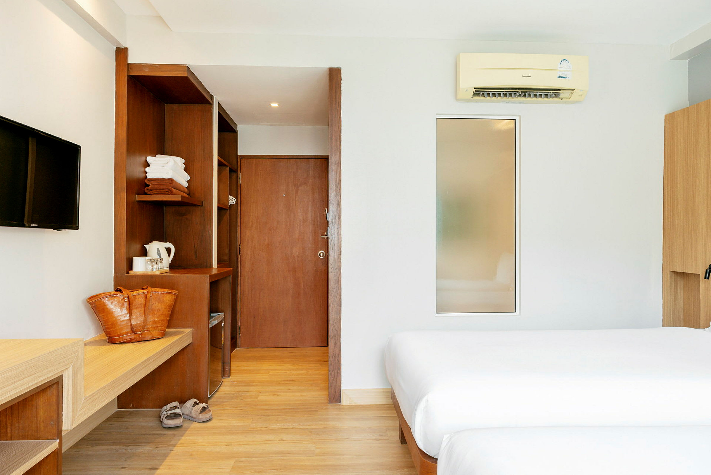 Hotellrum med två sängar, trädetaljer och modern inredning. (AI-genererad text)