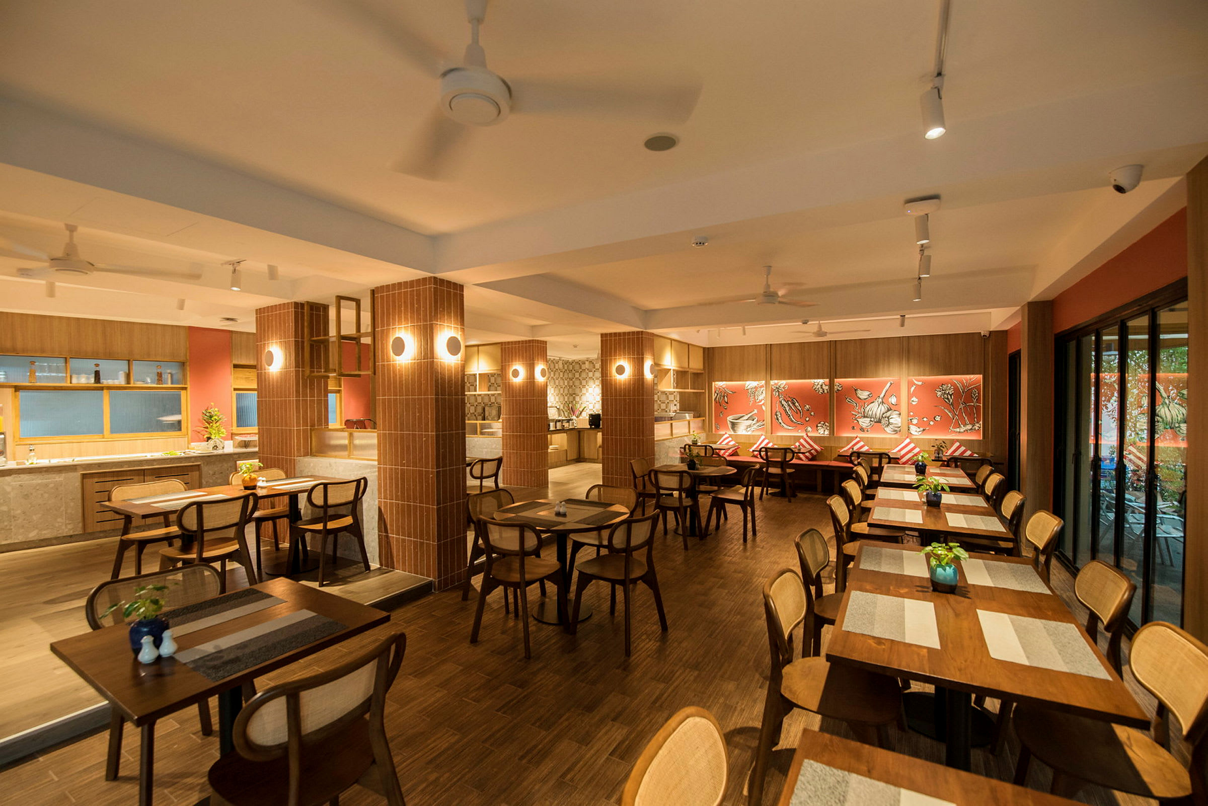 En restaurang med träbord och stolar, dekorerad med röda väggar och konstverk. (AI-genererad text)