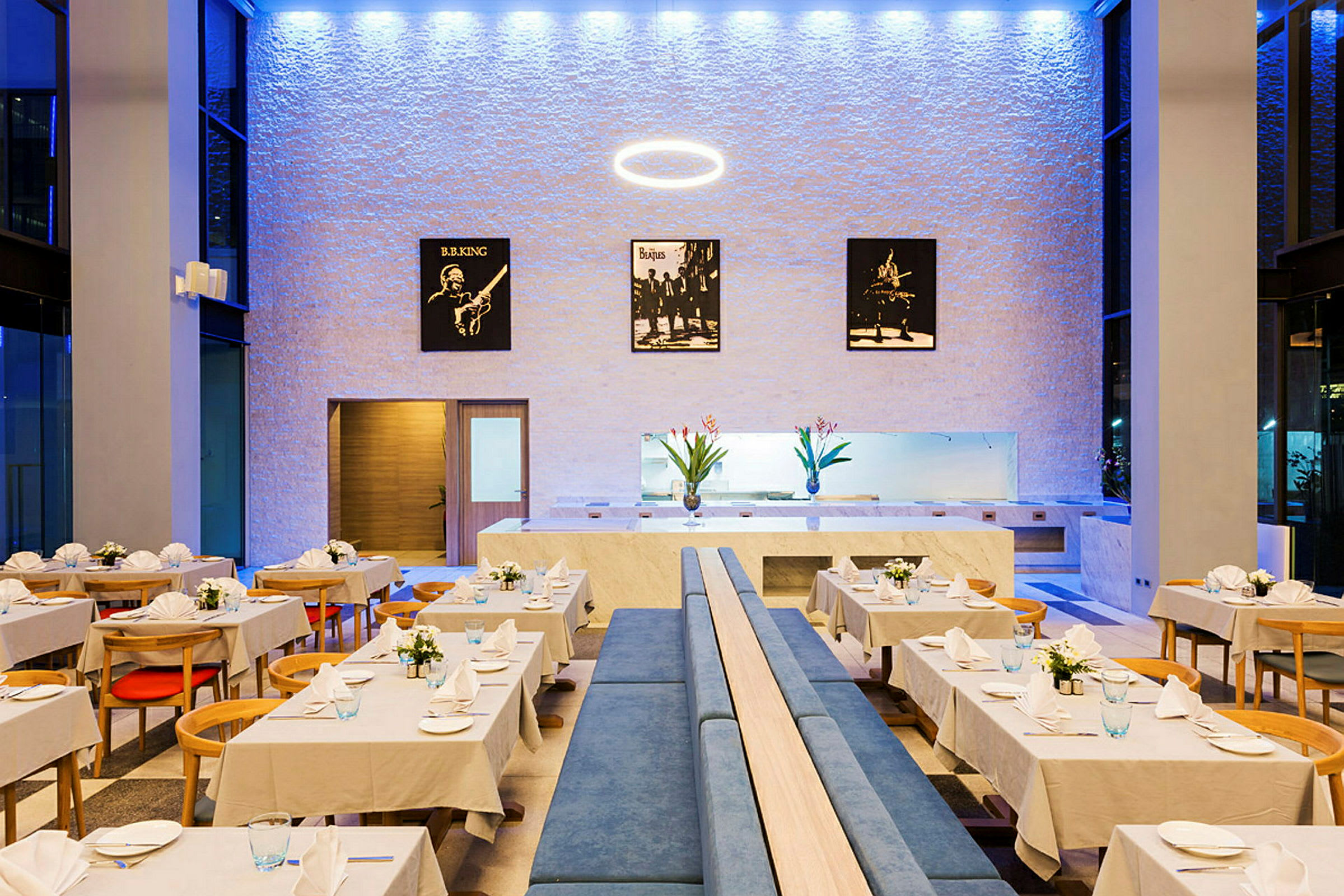 Interiör av en restaurang med dukade bord och dekorativa affischer på väggen. (AI-genererad text)
