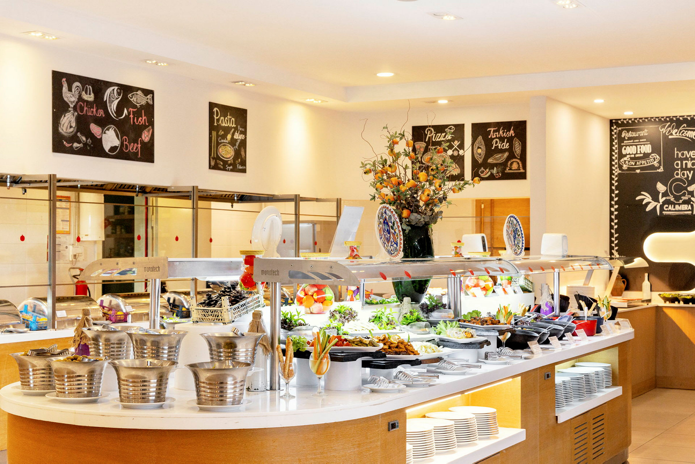 En buffé med diverse maträtter och dekorationer i en ljus restaurangmiljö. (AI-genererad text)