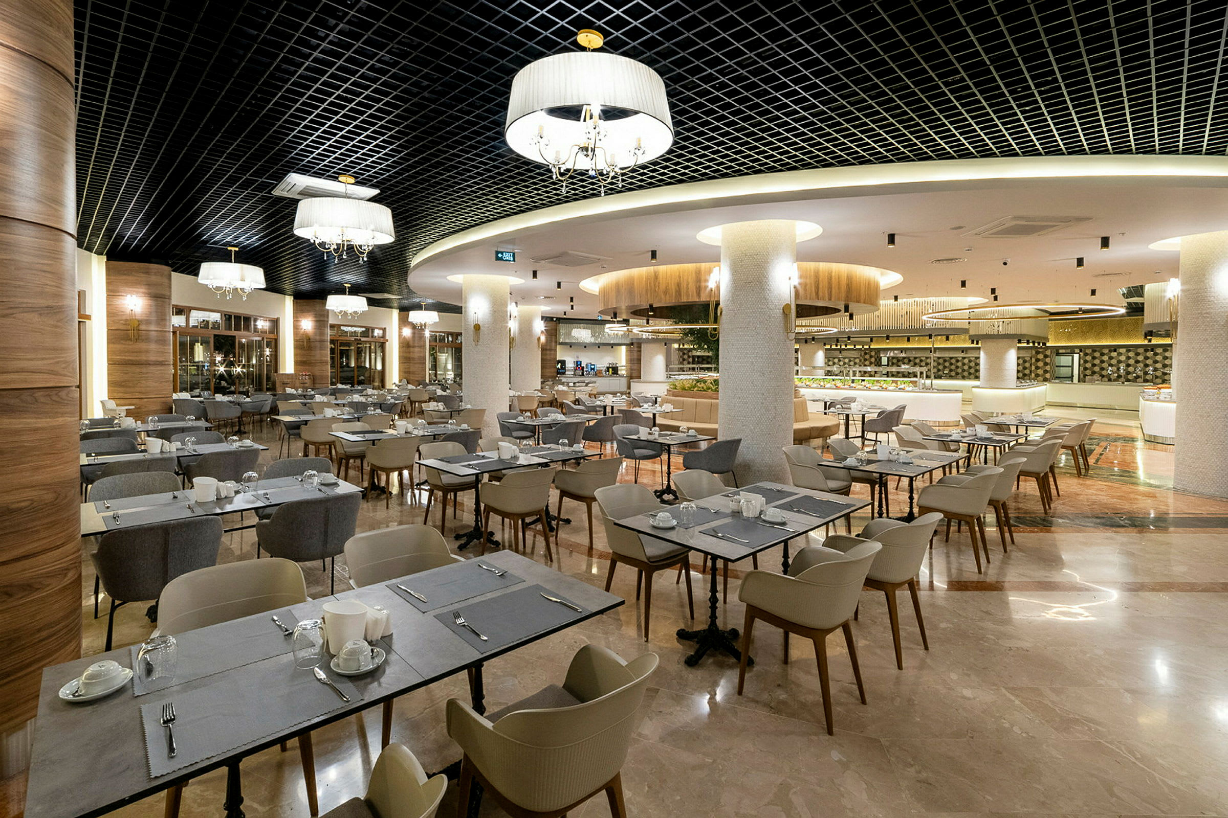 En restaurang med flera dukade bord och stolar, samt modernt tak och belysning. (AI-genererad text)