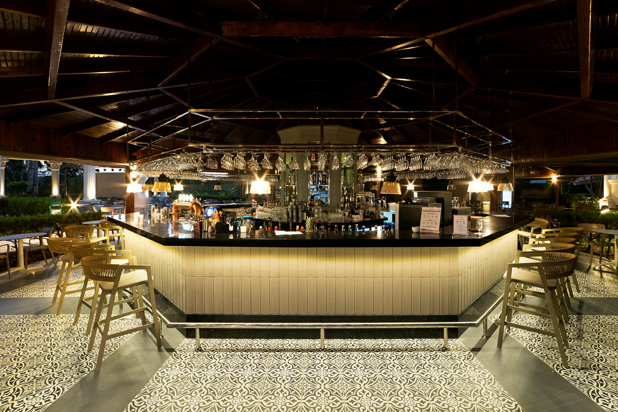 Inomhusbild av en elegant bar med belyst barområde och stolar. (AI-genererad text)