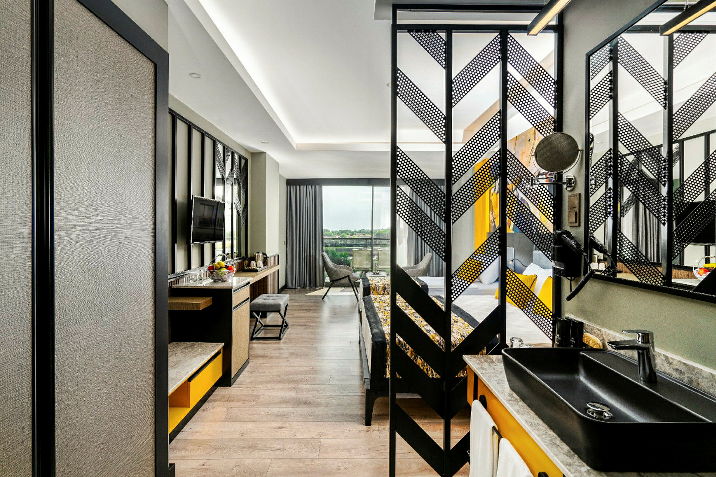 Bild av ett modernt hotellrum med skrivbord, stol och TV samt en separat sovdel. (AI-genererad text)