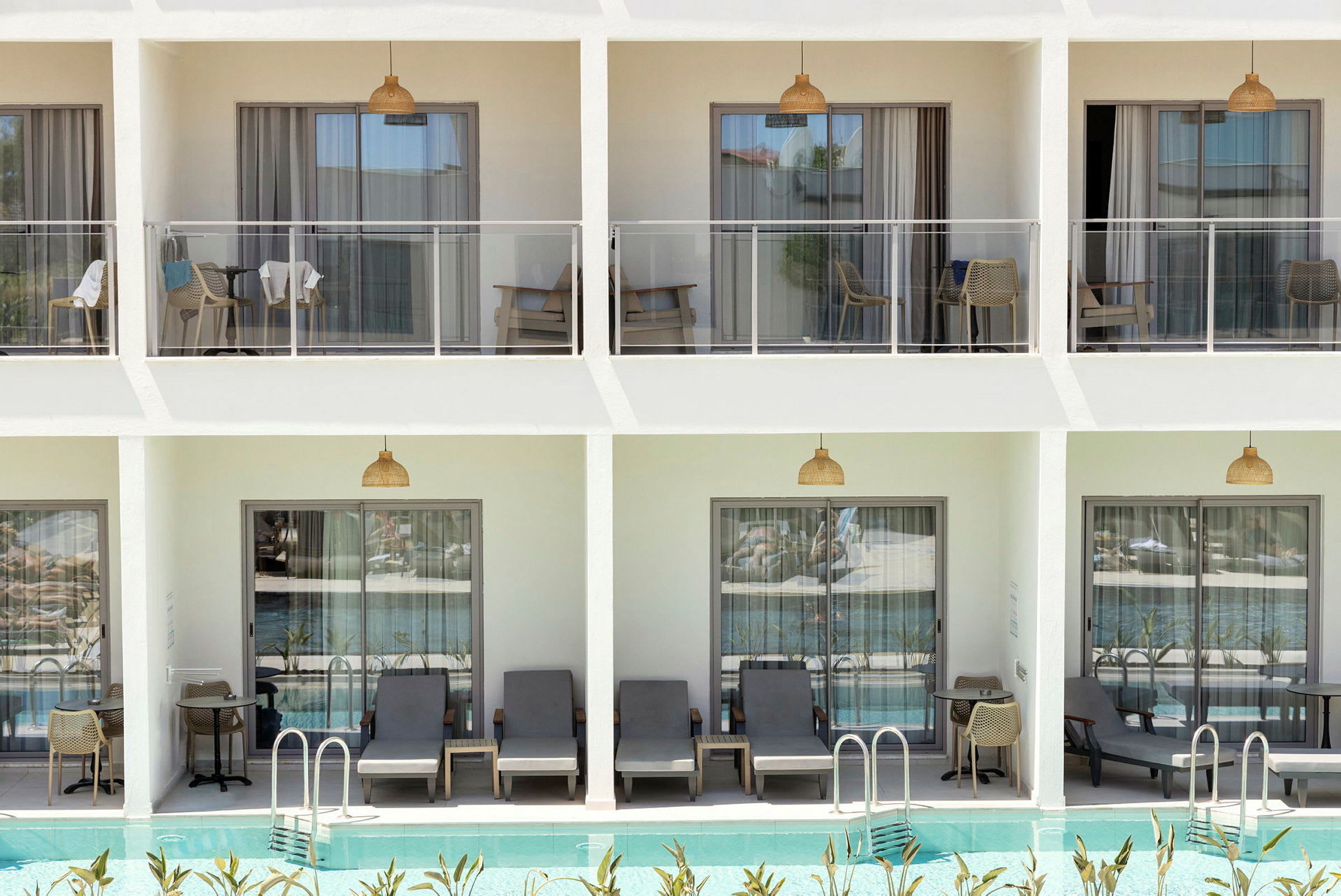 Bild av en modern hotellfasad med balkonger och direkt anslutning till en utomhuspool. (AI-genererad text)