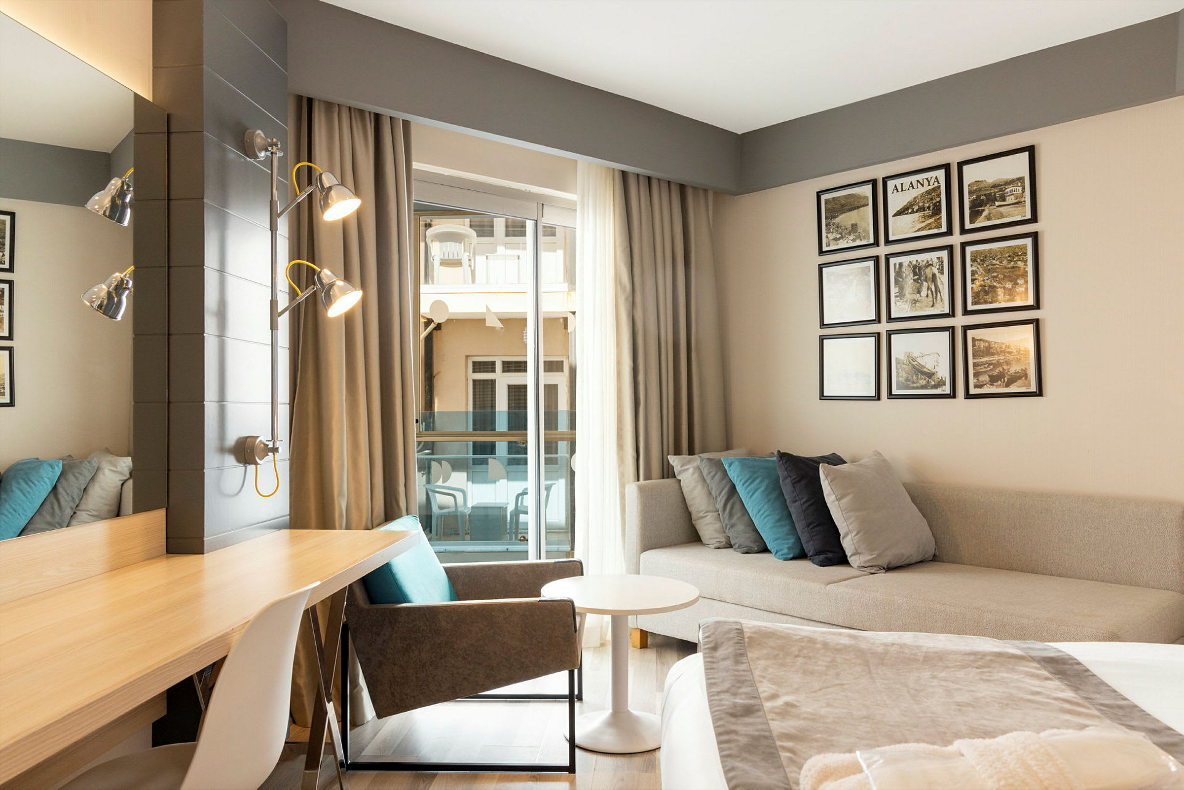 Hotellrum med skrivbord, soffa och dekorationer. (AI-genererad text)