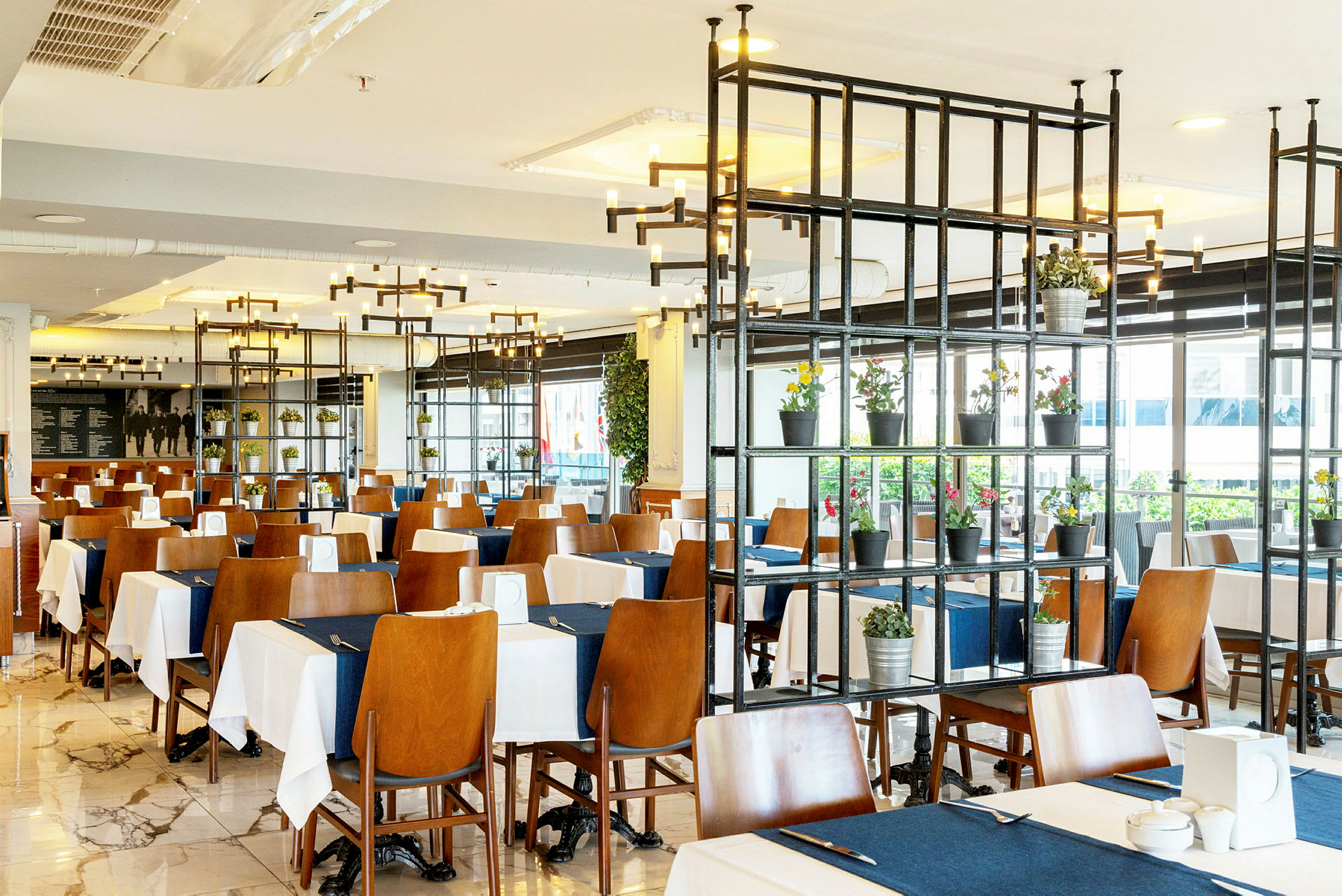 Restaurang med bord dukade med vita och blå dukar. (AI-genererad text)