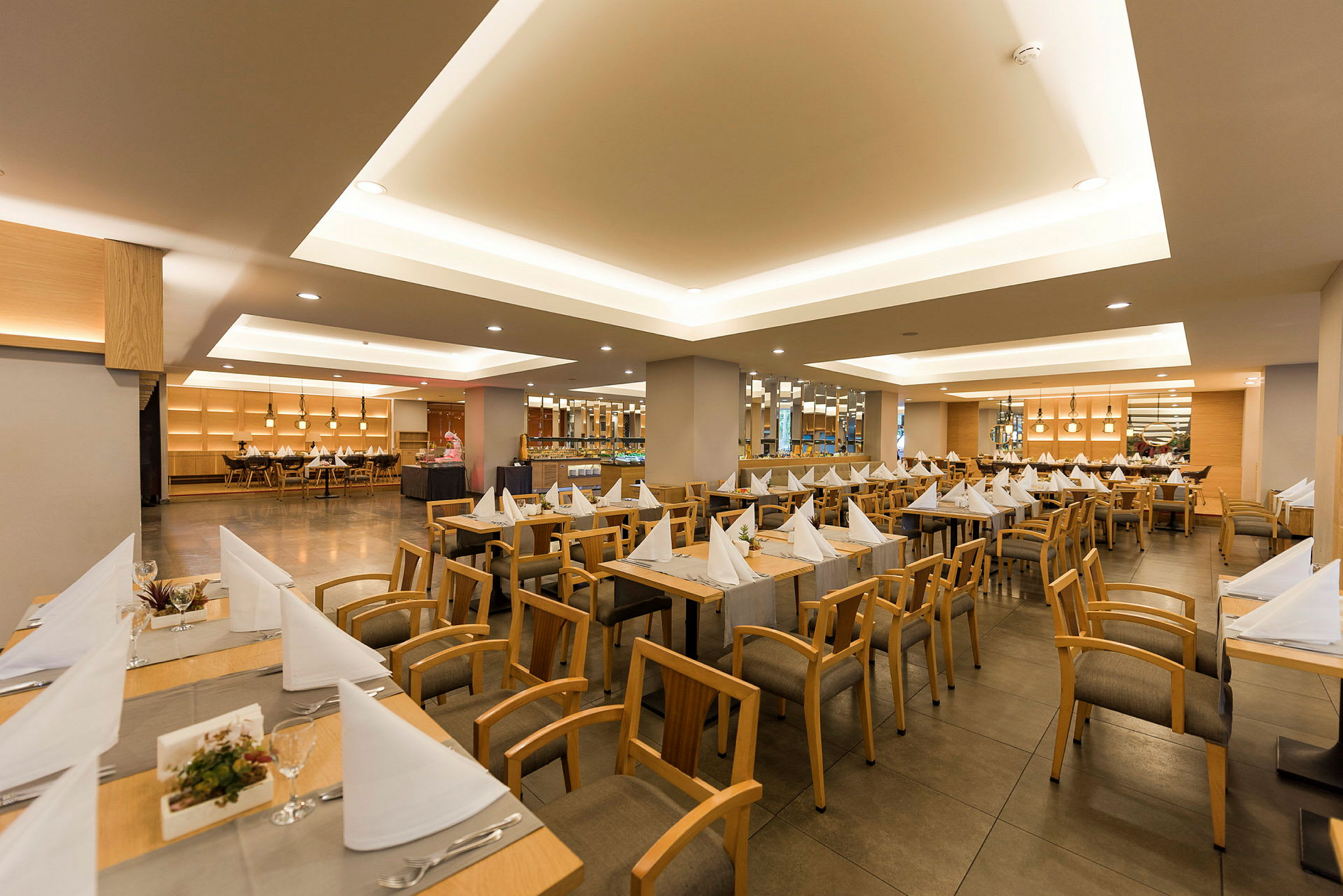 En restaurang med dukade bord och stolar. (AI-genererad text)