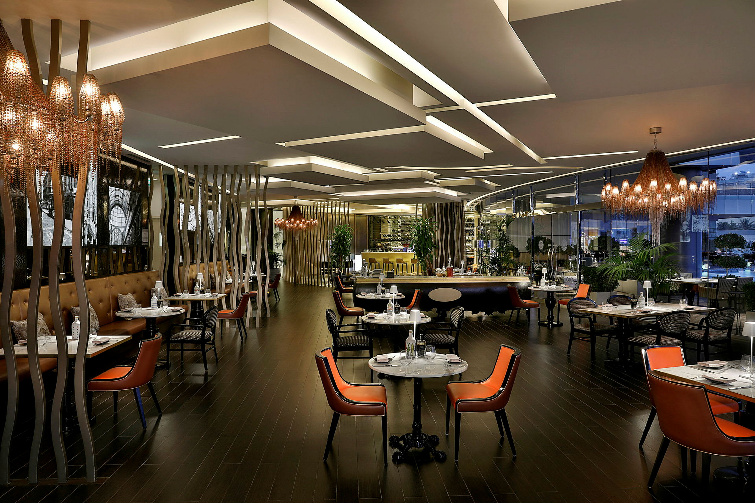 Interiör av en modern restaurang med belysning, bord och stolar. (AI-genererad text)