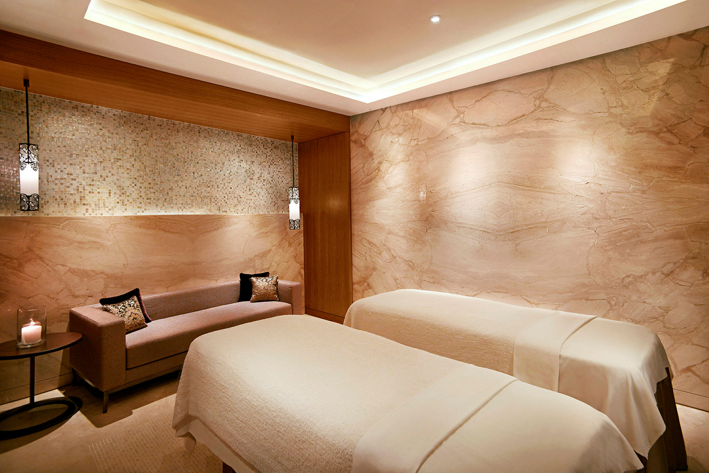 Ett spa-rum med två massagebänkar och en soffa. (AI-genererad text)