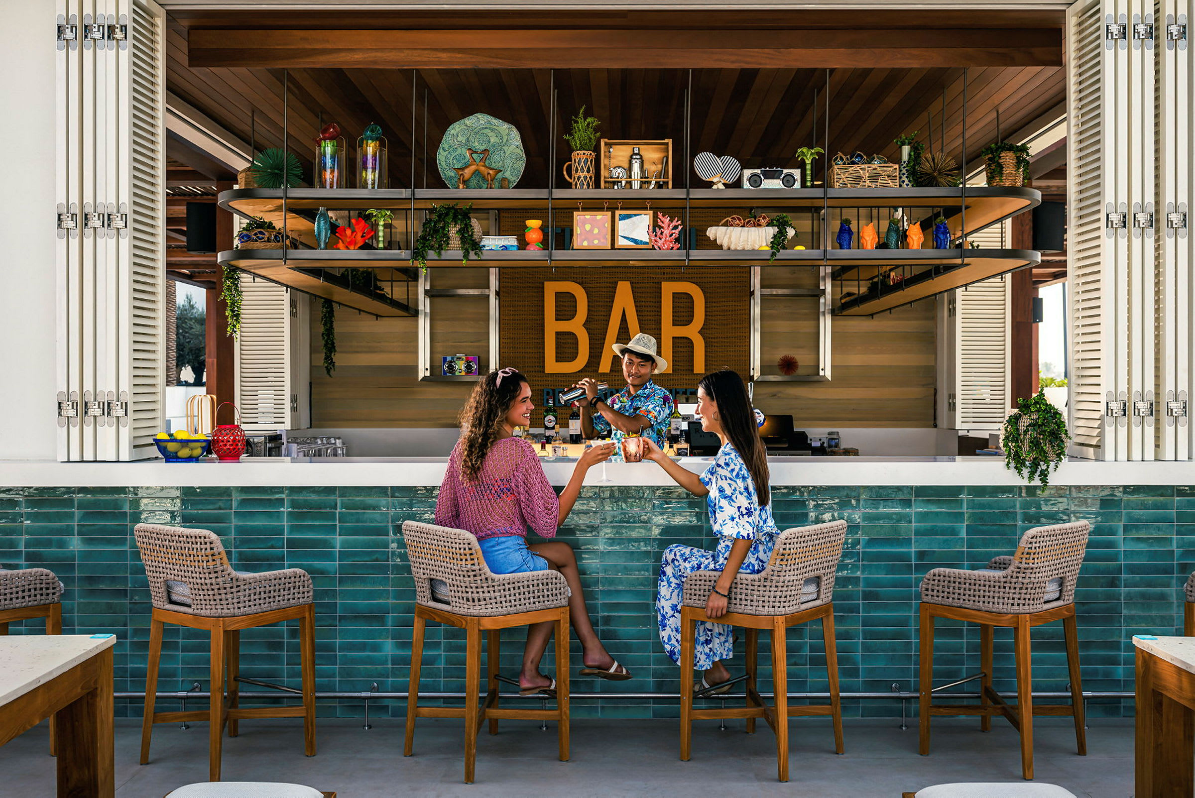 Två personer sitter vid en bar med en färgglad inredning. (AI-genererad text)