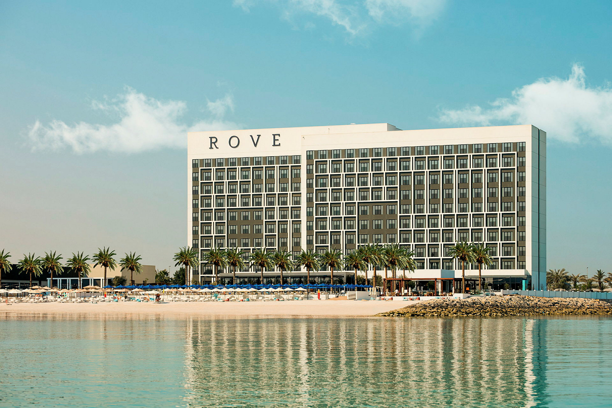 Ett hotell vid en strand med palmer. (AI-genererad text)