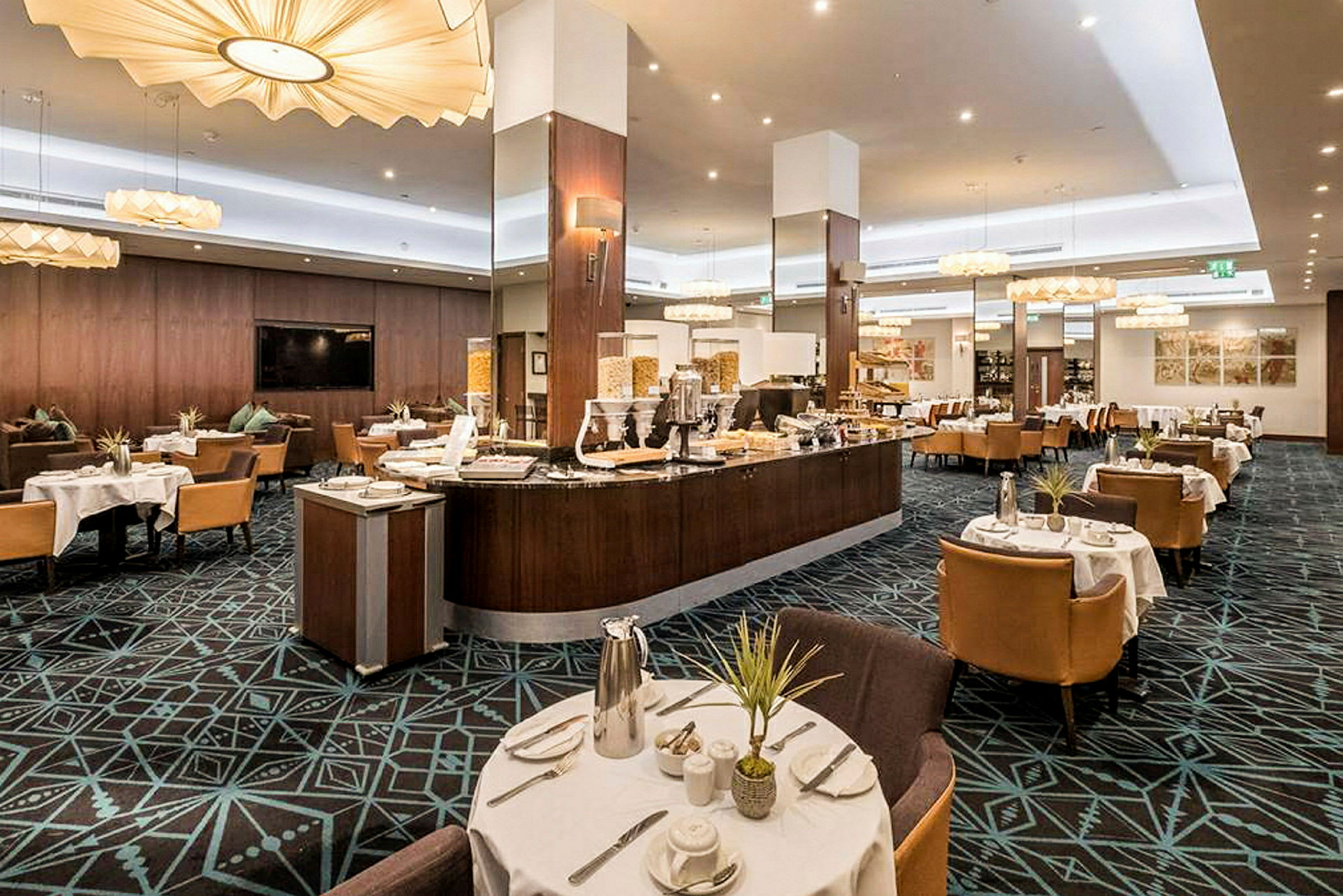 En modern restaurang med uppdukade bord och en bufféstation. (AI-genererad text)