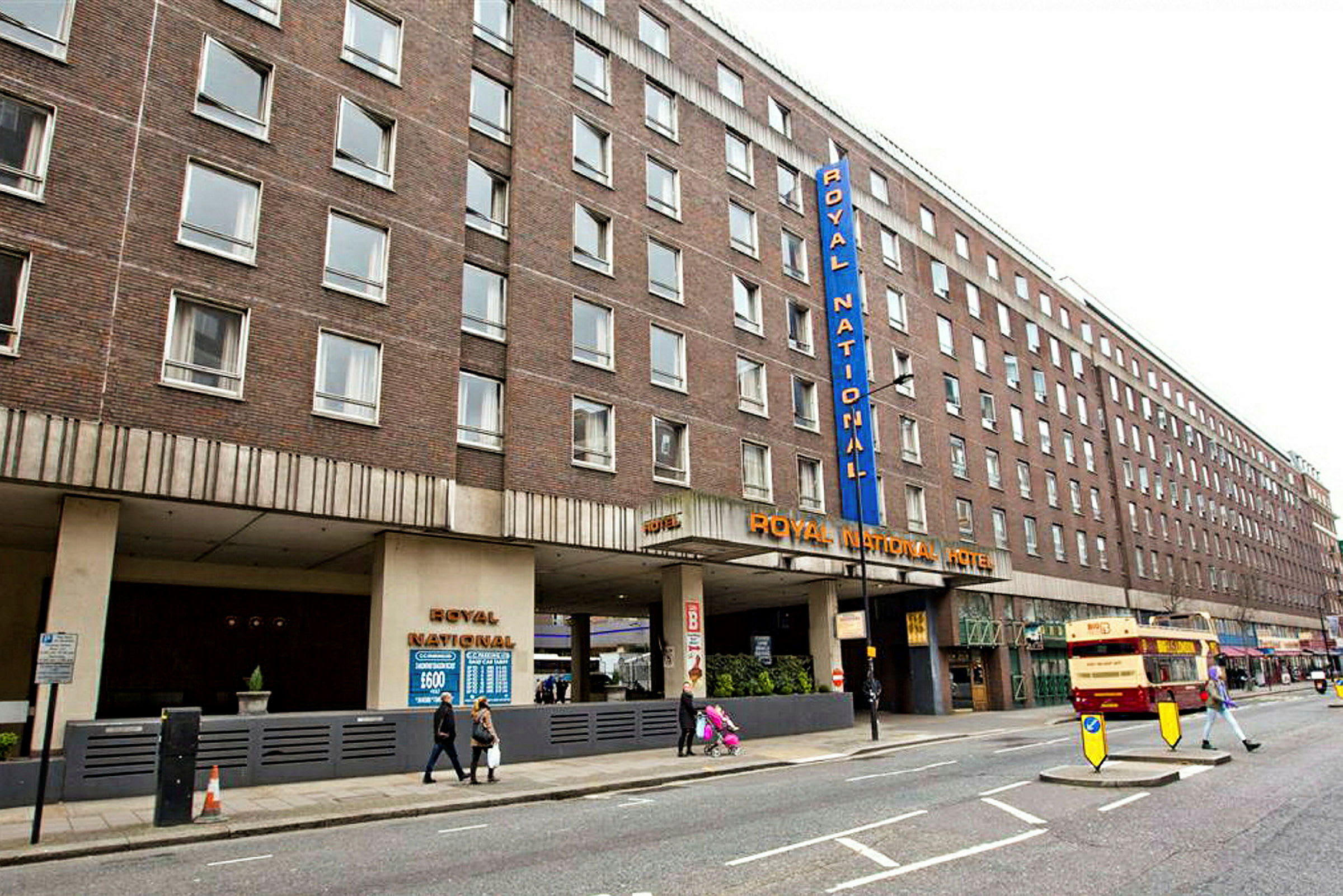En bild av Royal National Hotel i London, byggnaden är brun och har flera fönster. (AI-genererad text)