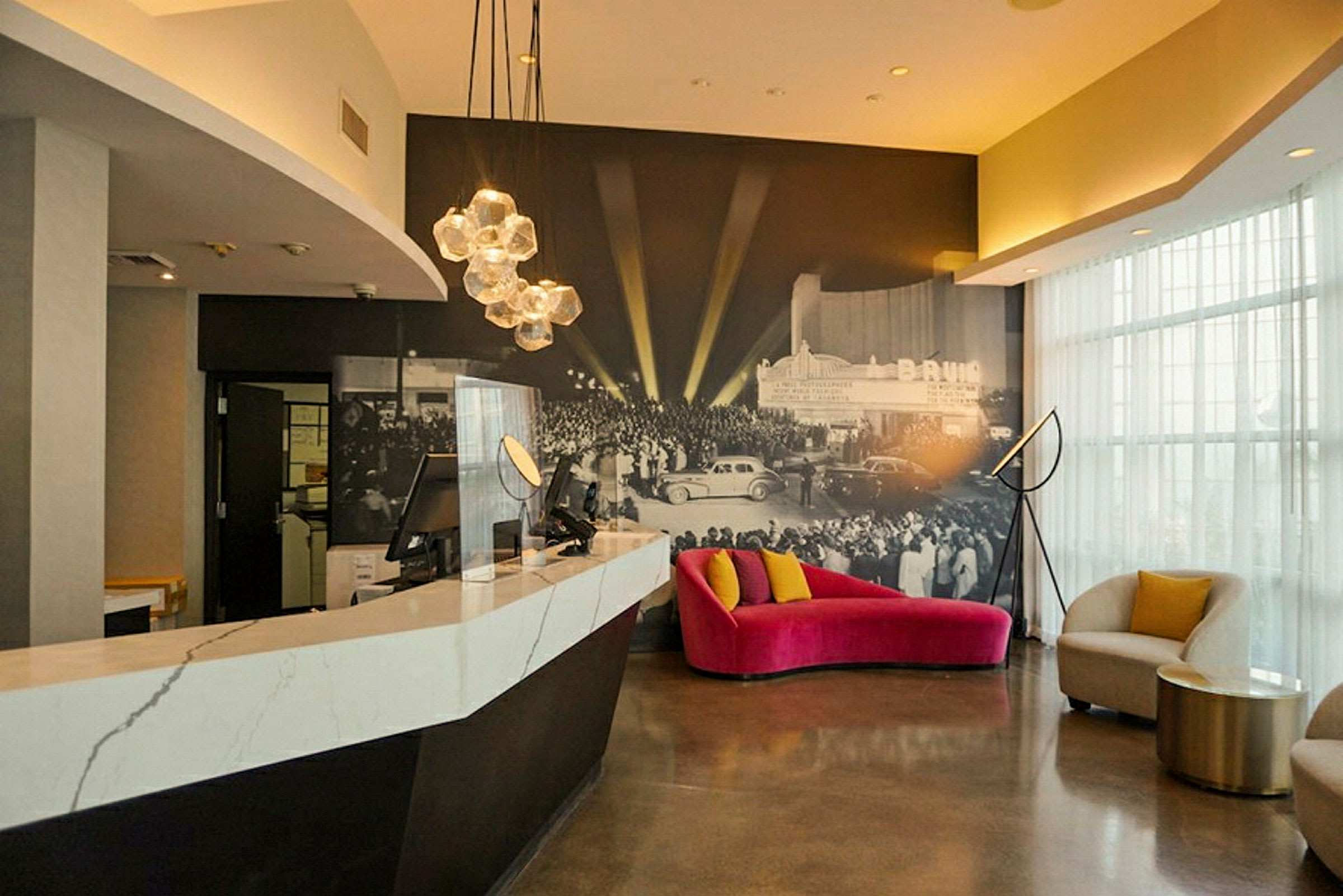 Reception- och sittområden med modern inredning och en väggmålning av ett evenemang. (AI-genererad text)