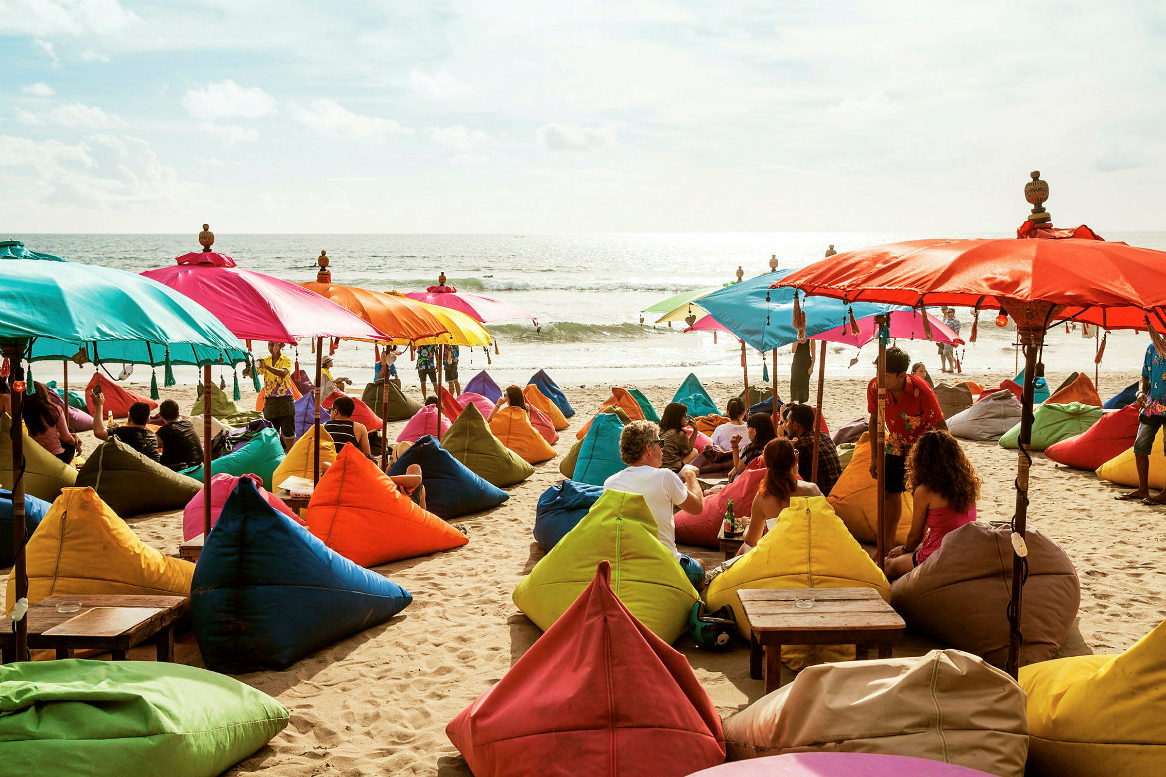 Strand med färgglada solparasoller och sittsäckar. (AI-genererad text)